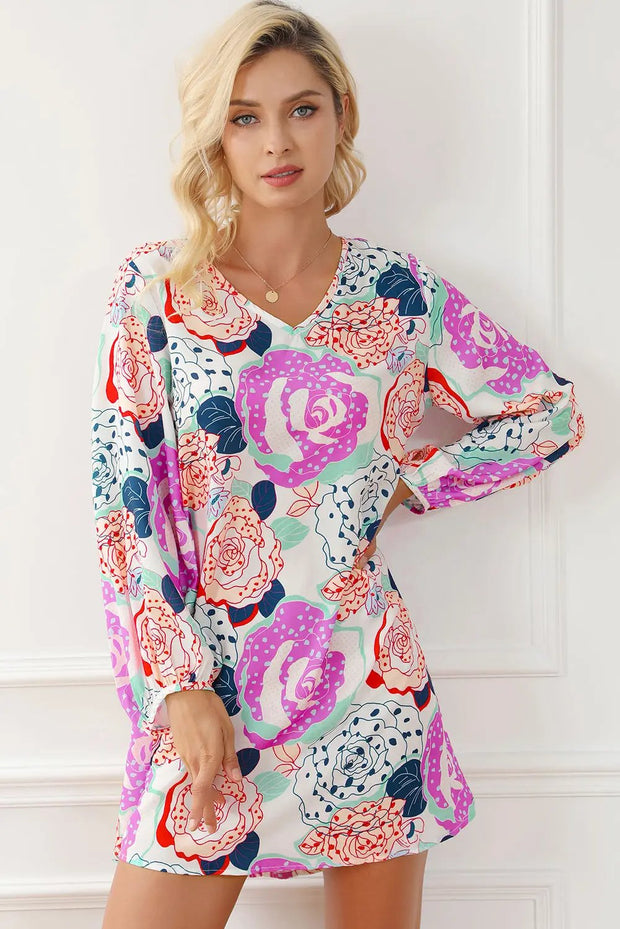 a woman posing in a floral print dress