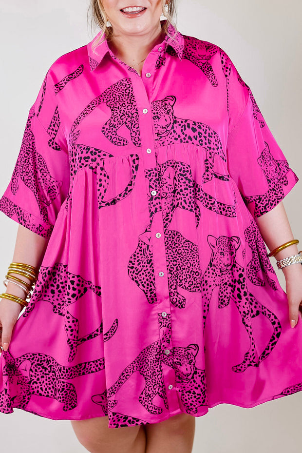 a woman wearing a pink shirt with a leopard print on it