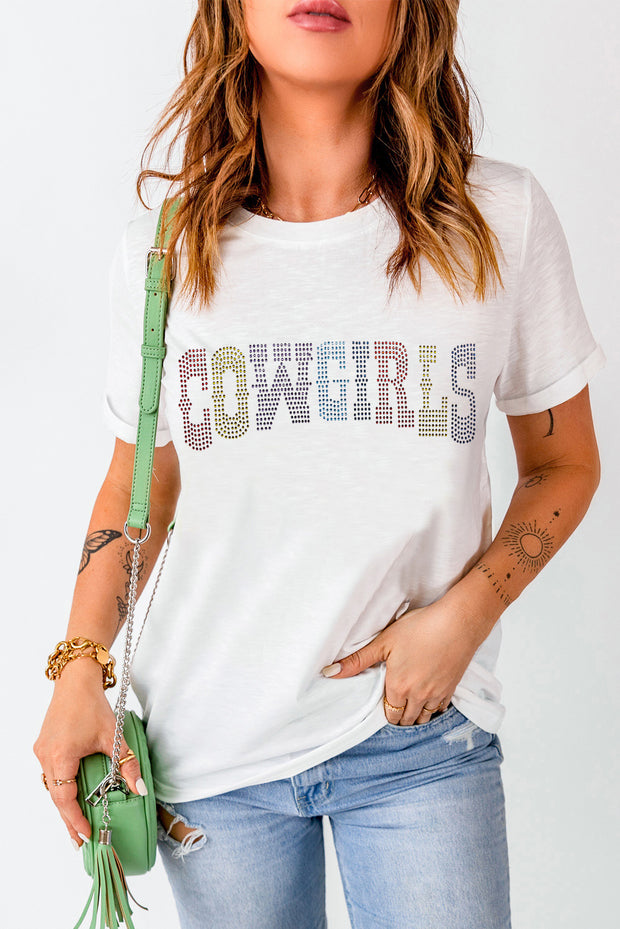 a woman wearing a white shirt with the word cowboys on it