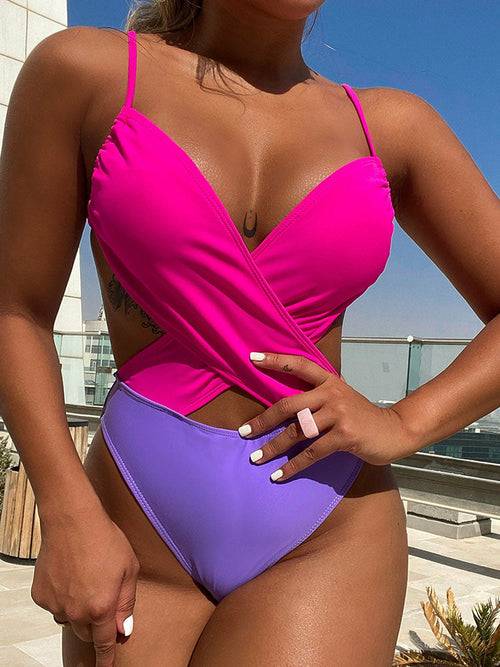 a woman in a pink and purple bikini