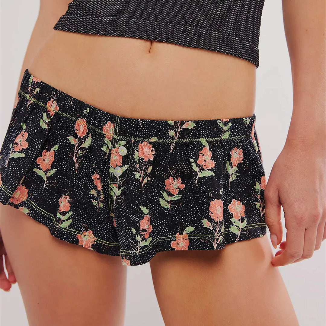 a close up of a woman's shorts with flowers on it