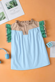 a blue top with a green ruffle on top of it