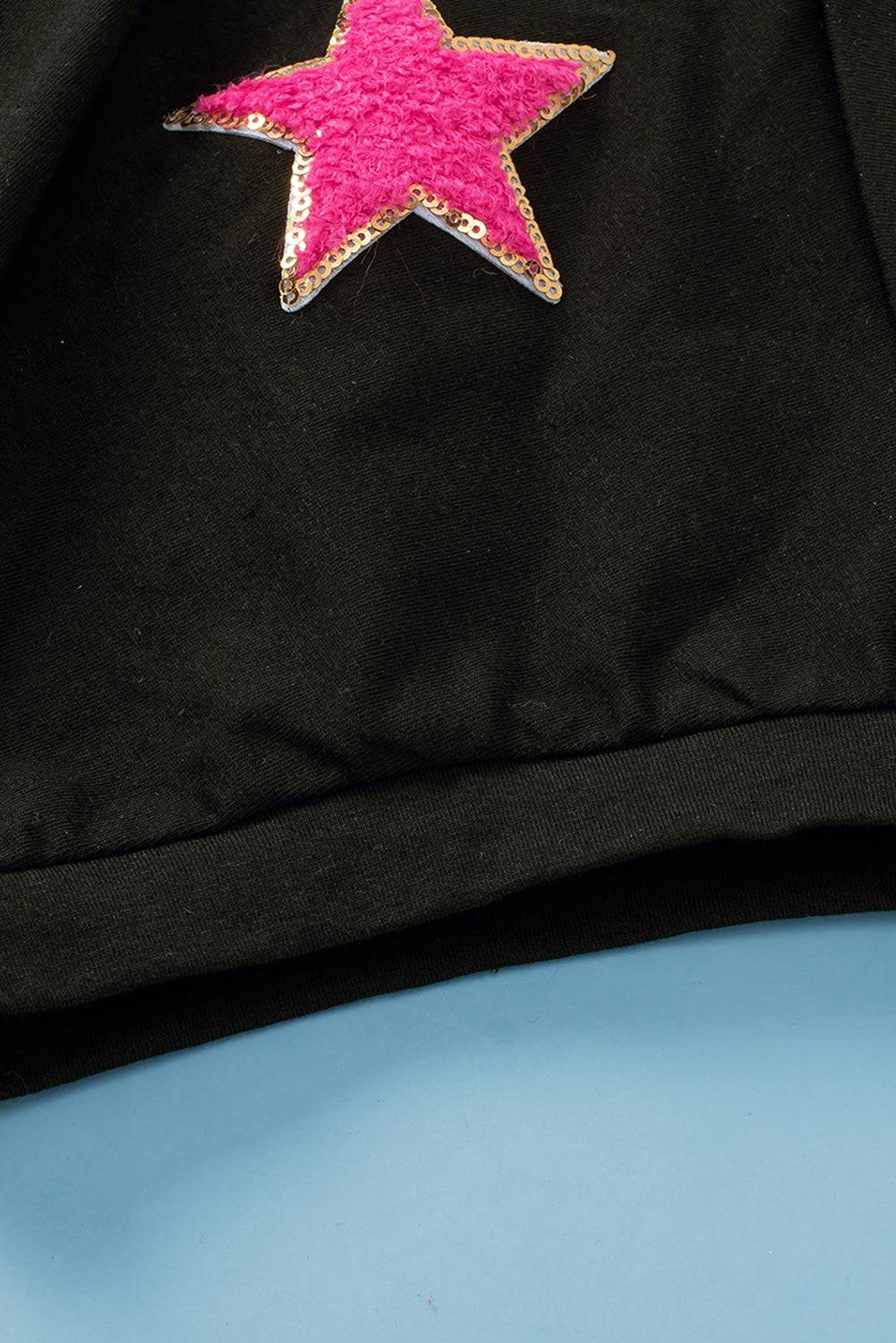 a black jacket with a pink star on it