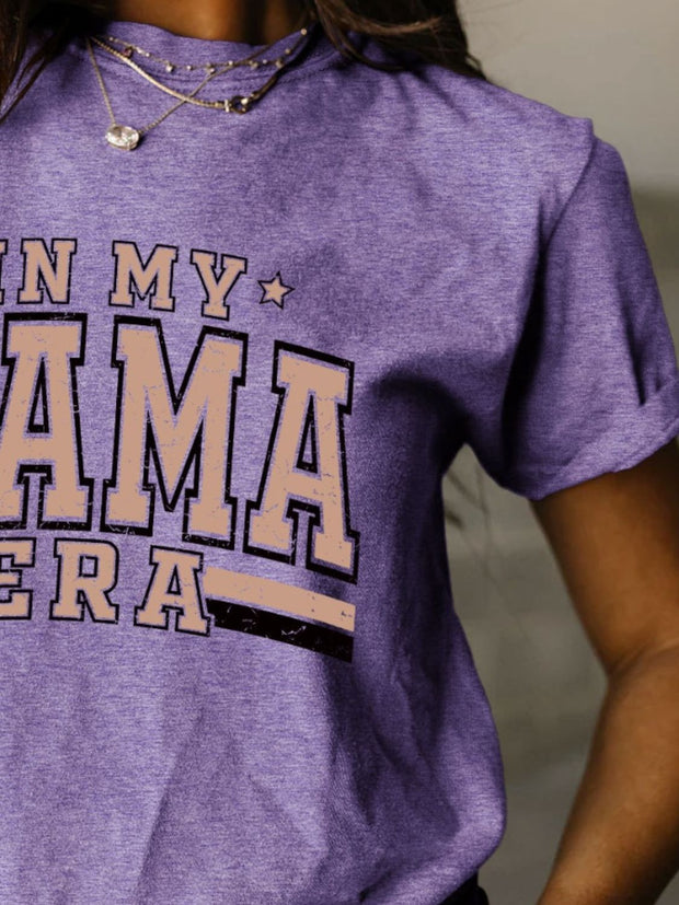 a woman wearing a purple shirt that says in my mama era