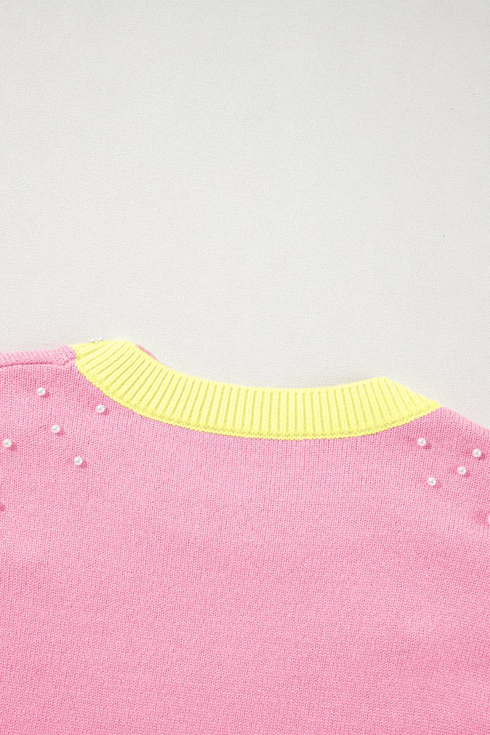 a close up of a pink shirt with yellow trim