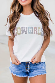 a woman wearing a white t - shirt with the word flowers printed on it