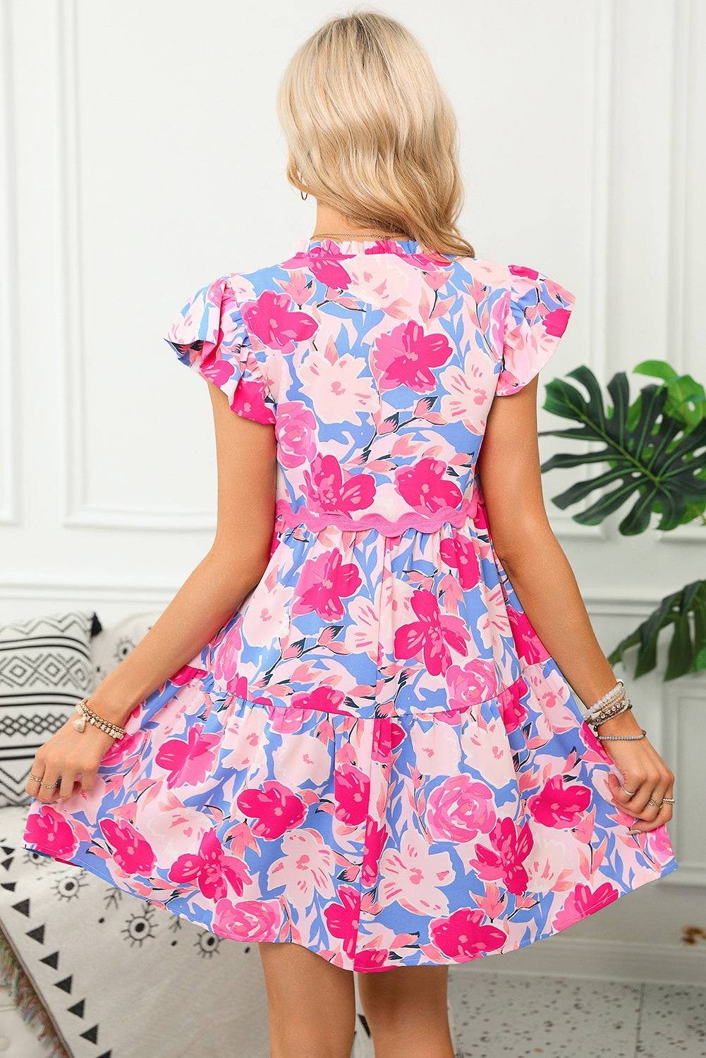 Back view of Pink Floral Printed V Notched Ric Rac Flutter Sleeve Dress with tiered A-line cut. Perfect for summer occasions at Faith & Co. Boutique.