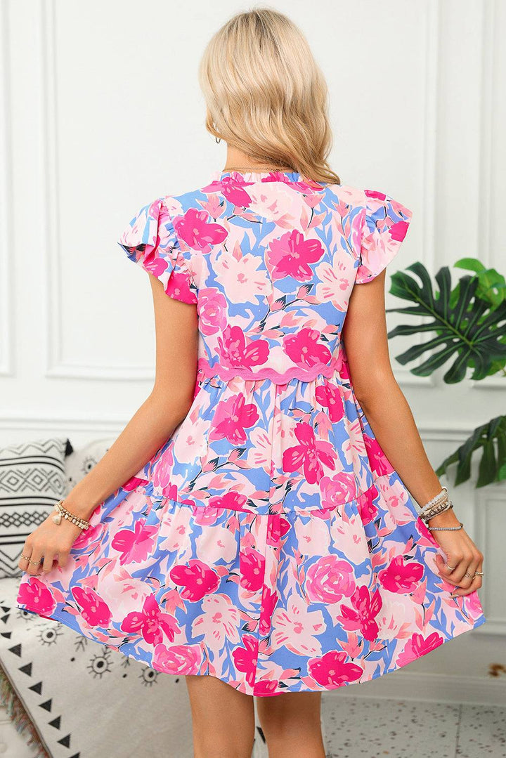 Back view of Pink Floral Printed V Notched Ric Rac Flutter Sleeve Dress with tiered A-line cut. Perfect for summer occasions at Faith & Co. Boutique.