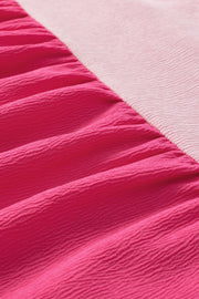 a close up of a pink and white bedspread