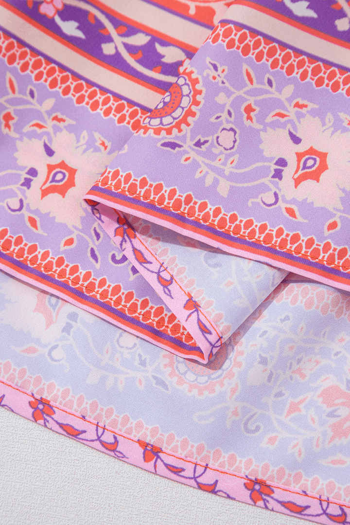 hem detail of Red Floral Print Tasseled Tied Sleeve Empire Waist Maxi Dress, showing layered purple and red floral border print