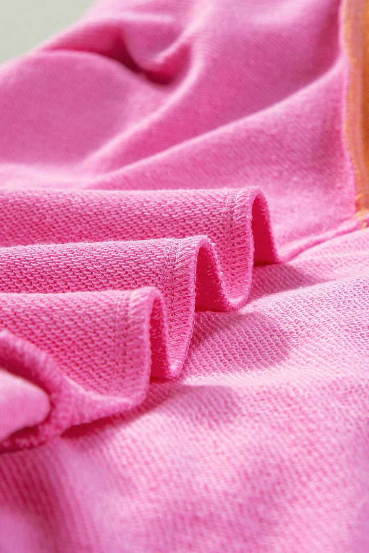 a close up of a pink shirt with ruffles