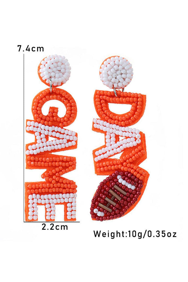 a pair of orange and white beaded earrings