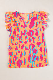 an orange top with blue and pink designs on it