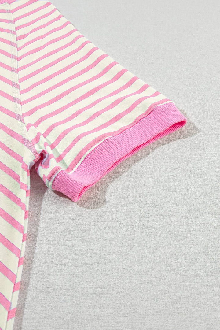 a pink and white striped shirt laying on a white surface