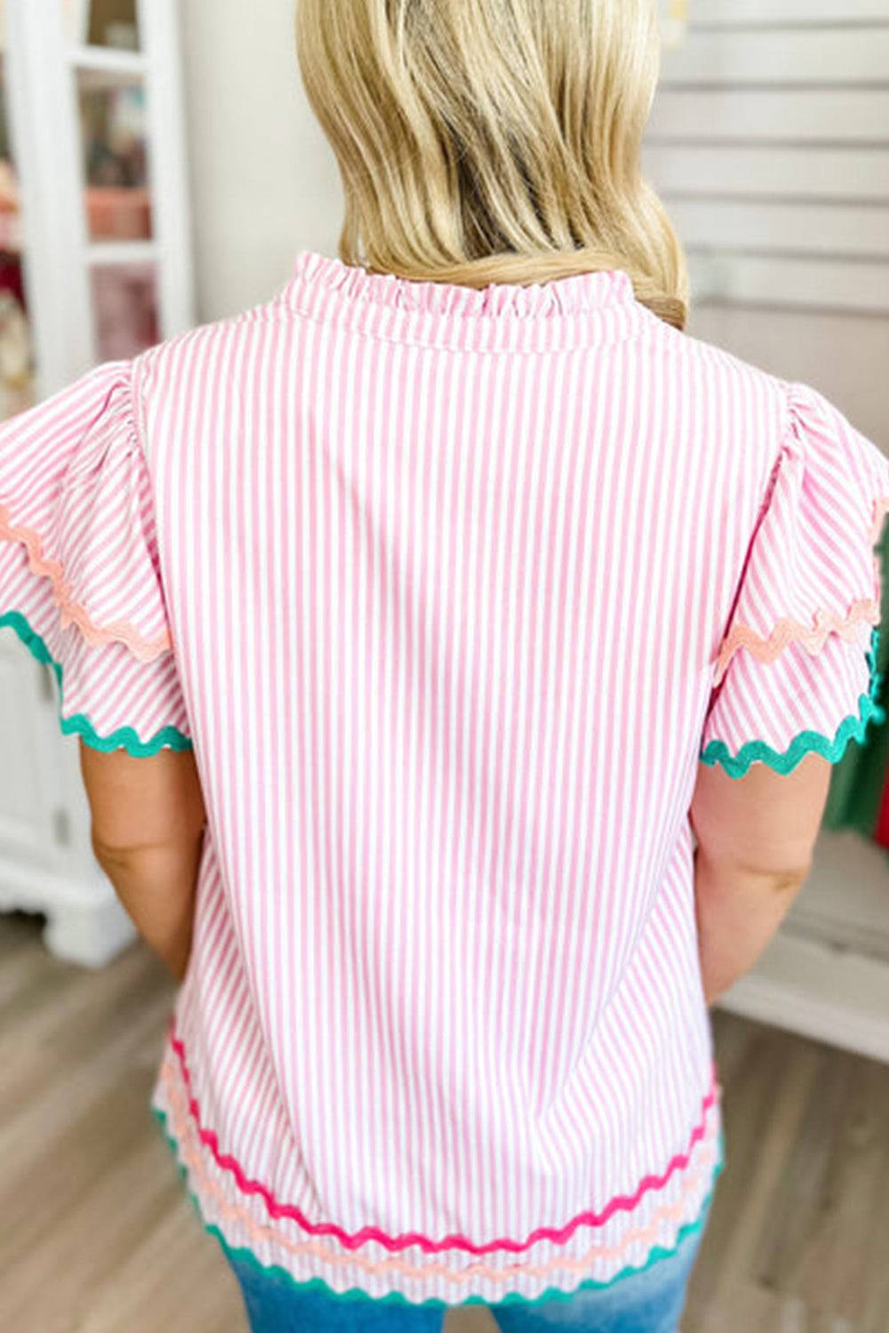 a woman wearing a pink and white striped top