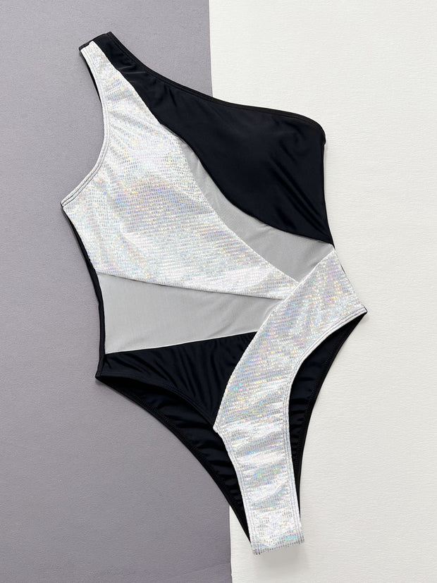 a white and black one piece swimsuit on a gray and white background