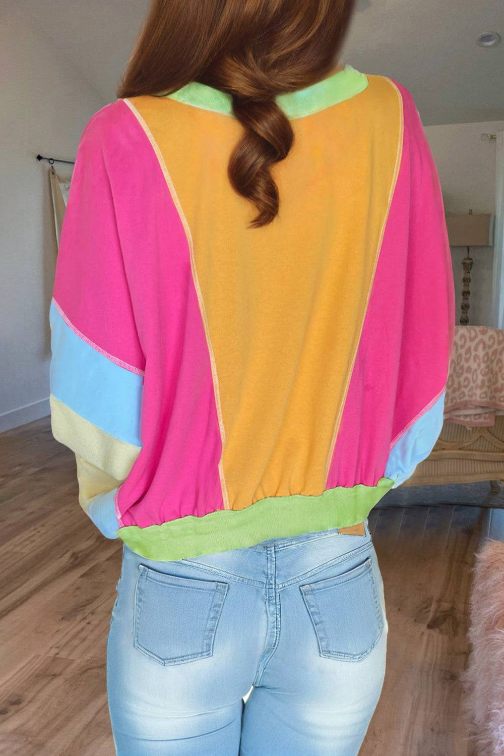 the back of a woman wearing a colorful top