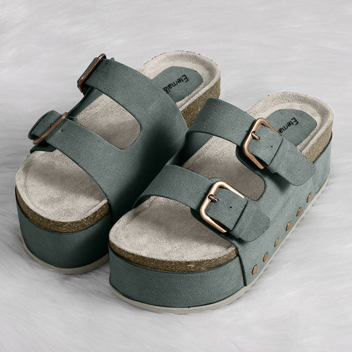 a pair of green sandals on a white surface