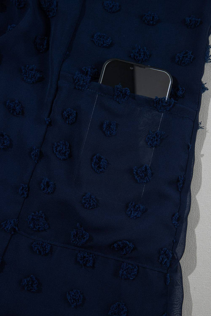 Pocket detail of Navy Blue Dotty Textured Notched Neck Plus Ruffled Dress with smartphone inside, showcasing functionality and style.