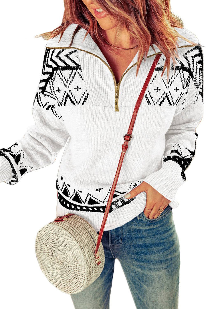 a woman wearing a white sweater and a straw hat