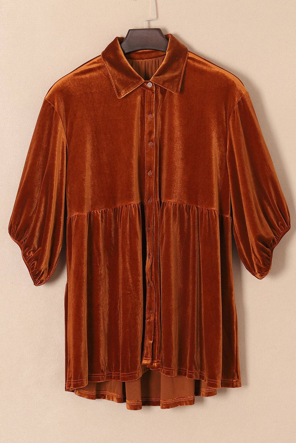 a brown shirt hanging on a hanger