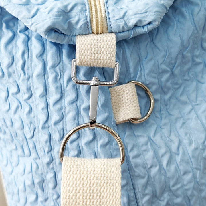 a close up of a blue and white bag