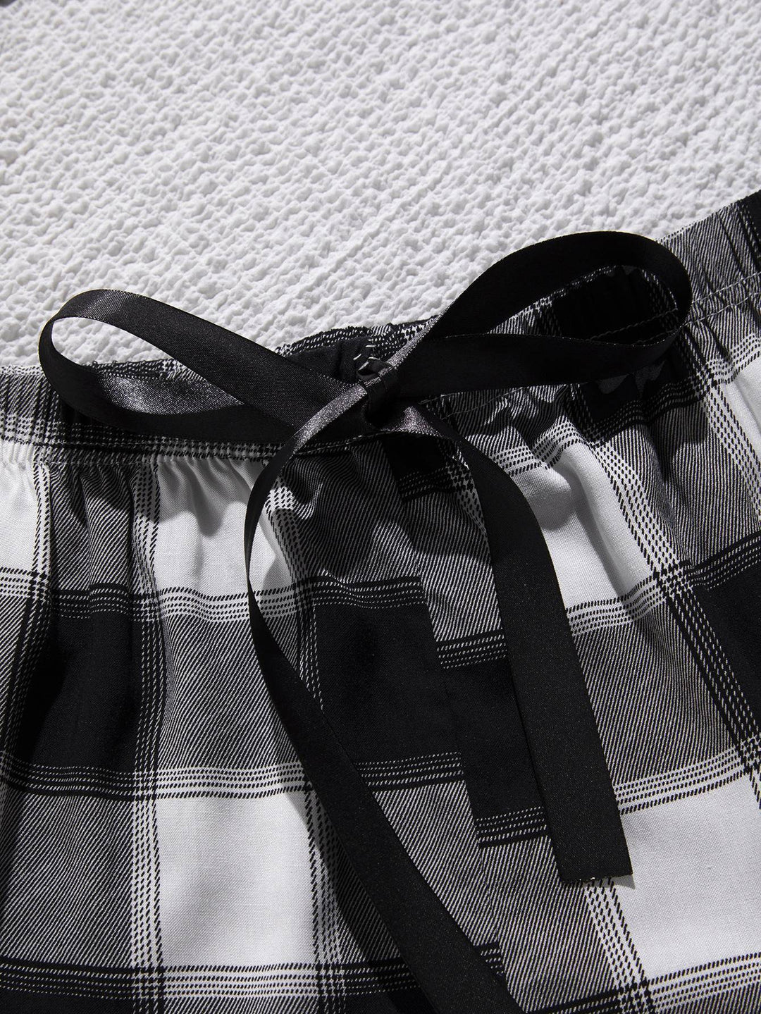 a close up of a black and white checkered shorts