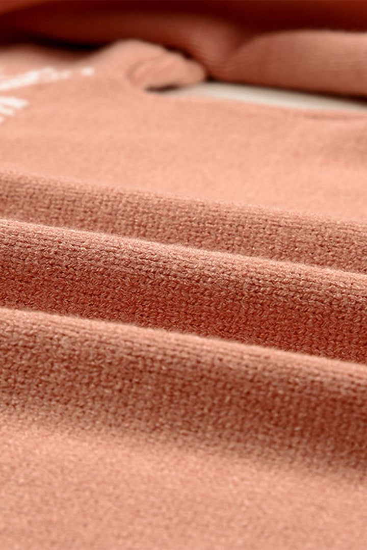 a close up of a pink blanket on a bed