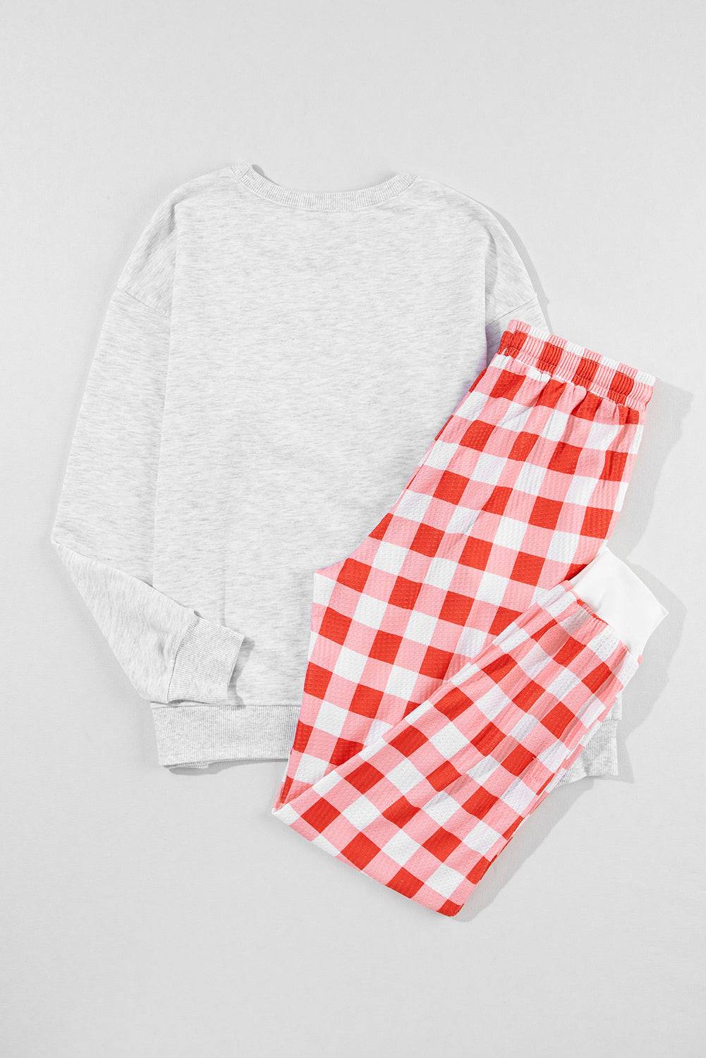 a red and white checkered pajama set on a white background