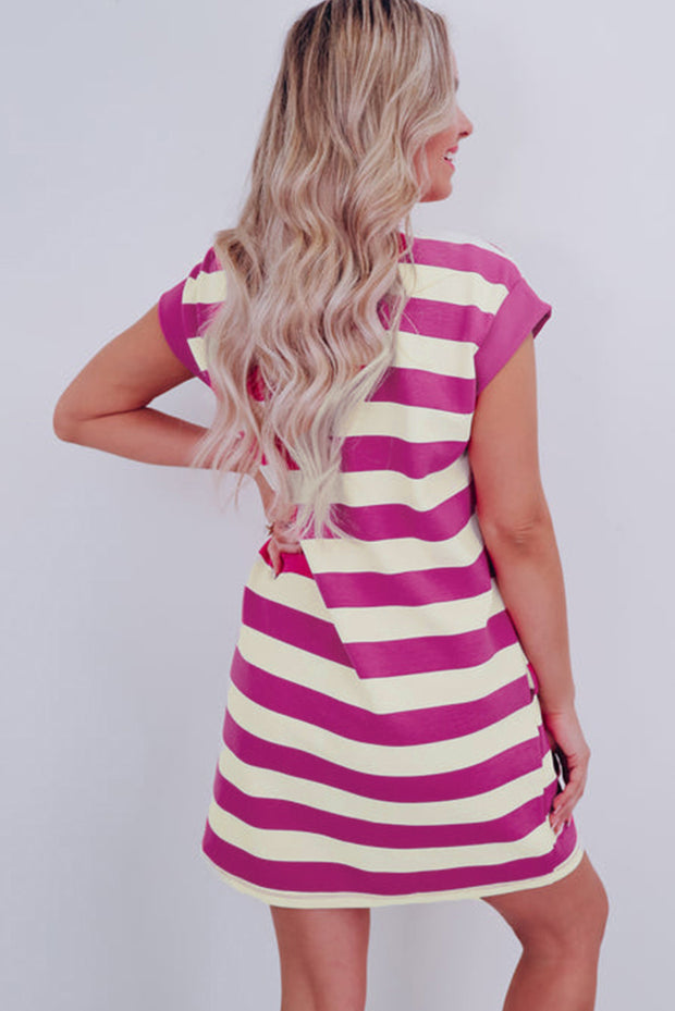 a woman in a pink and white striped dress