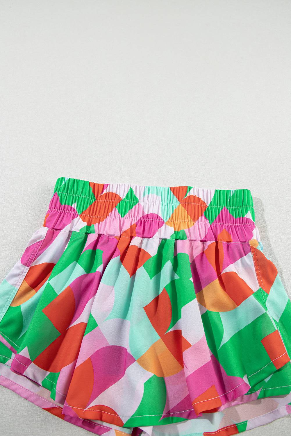 a colorful skirt is laying on a white surface