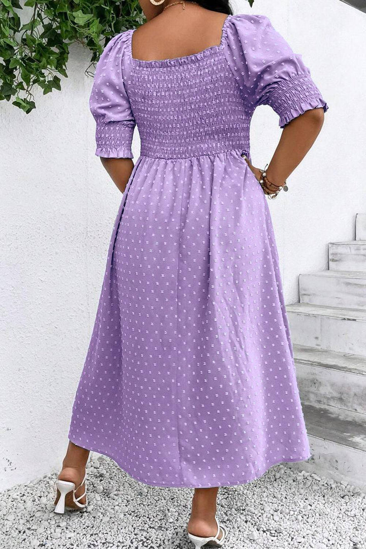 Back view of Wisteria Swiss Dot Smocked Frilled Neckline Plus Size Dress showing smocked bodice and puff sleeves in elegant lavender tone.