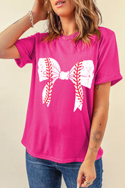 a woman wearing a pink baseball shirt with a bow