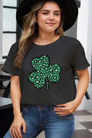 a woman wearing a black shirt with a green clover on it