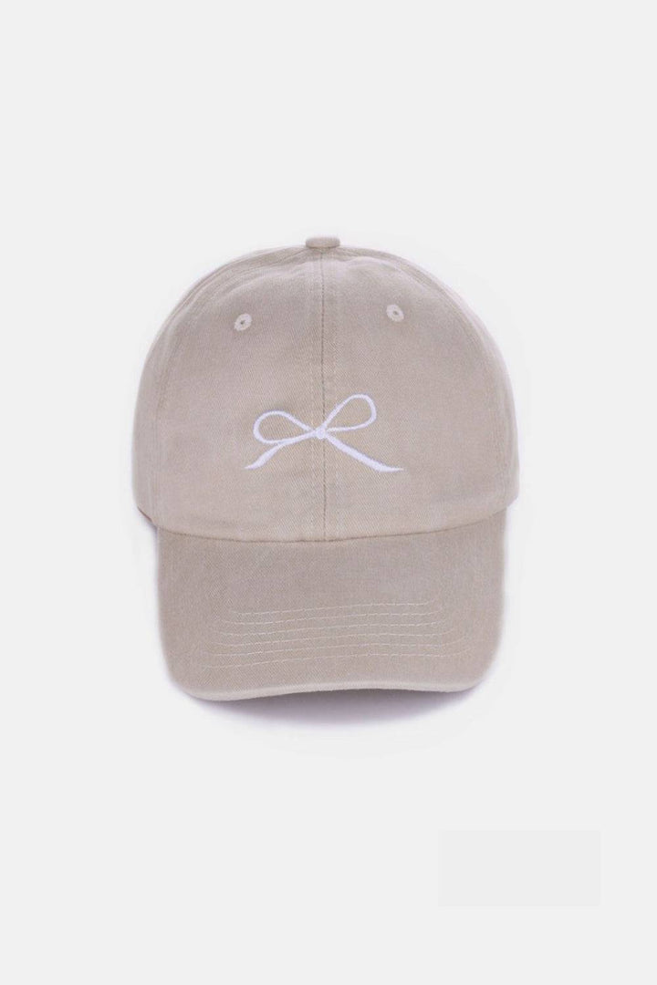 a tan hat with a white bow on it