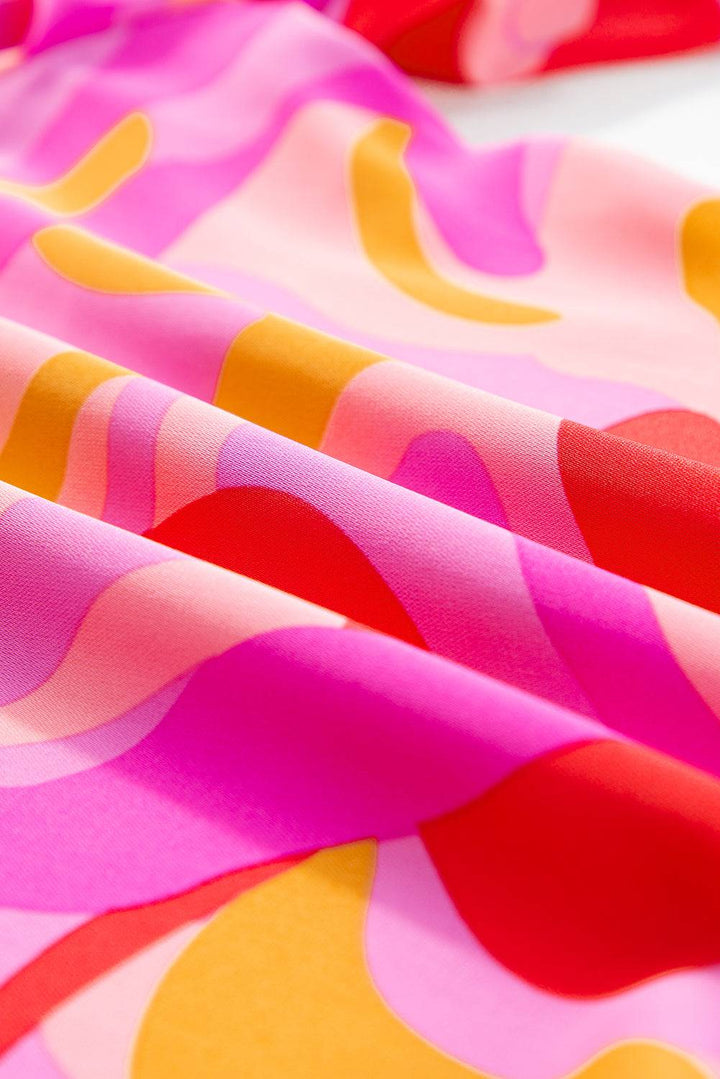 a close up of a pink, yellow, and red fabric