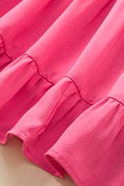 a close up of a pink dress with ruffles