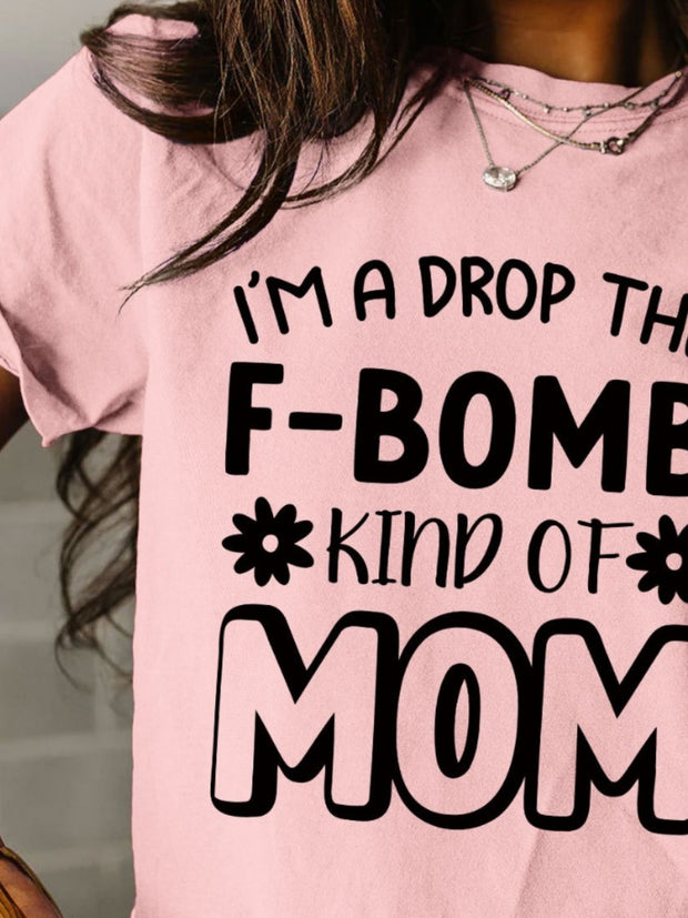 a woman wearing a pink shirt that says i'm a drop the f -
