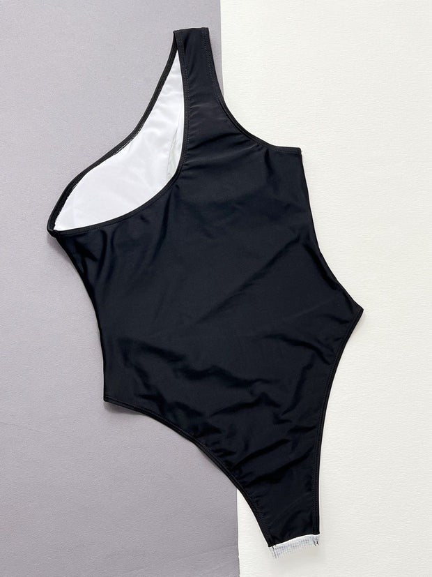 a women's black and white one piece swimsuit