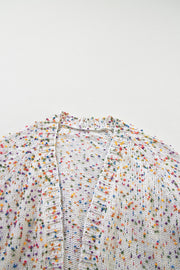 a white umbrella with multicolored dots on it