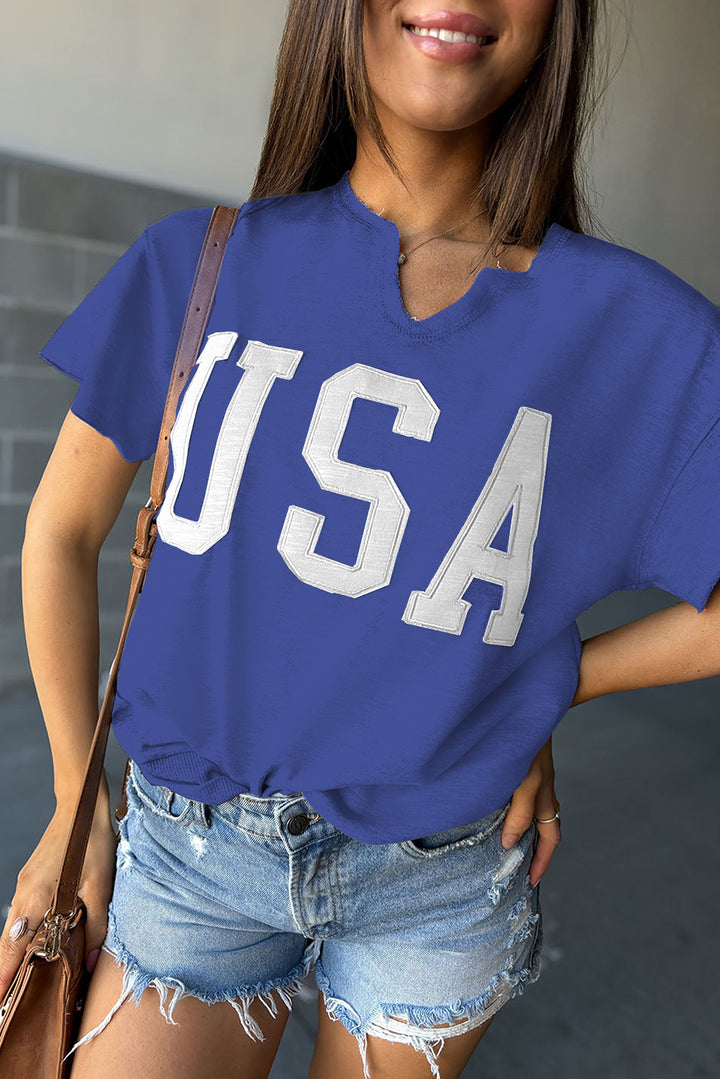 a woman wearing a blue shirt with the word usa on it