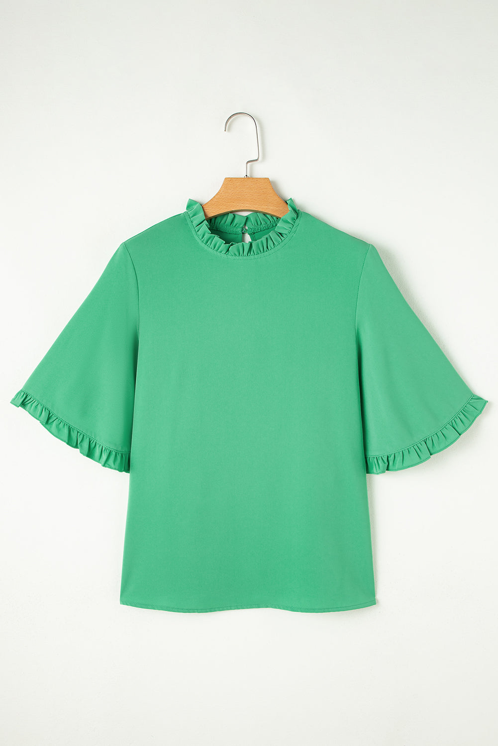 Flat lay front view of Green Frilly Round Neck Wide Half Sleeve Blouse on hanger, highlighting ruffle details and solid green color.