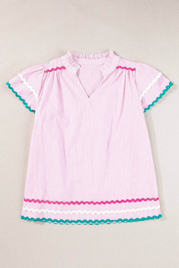 a girl's pink and white striped dress with frilles