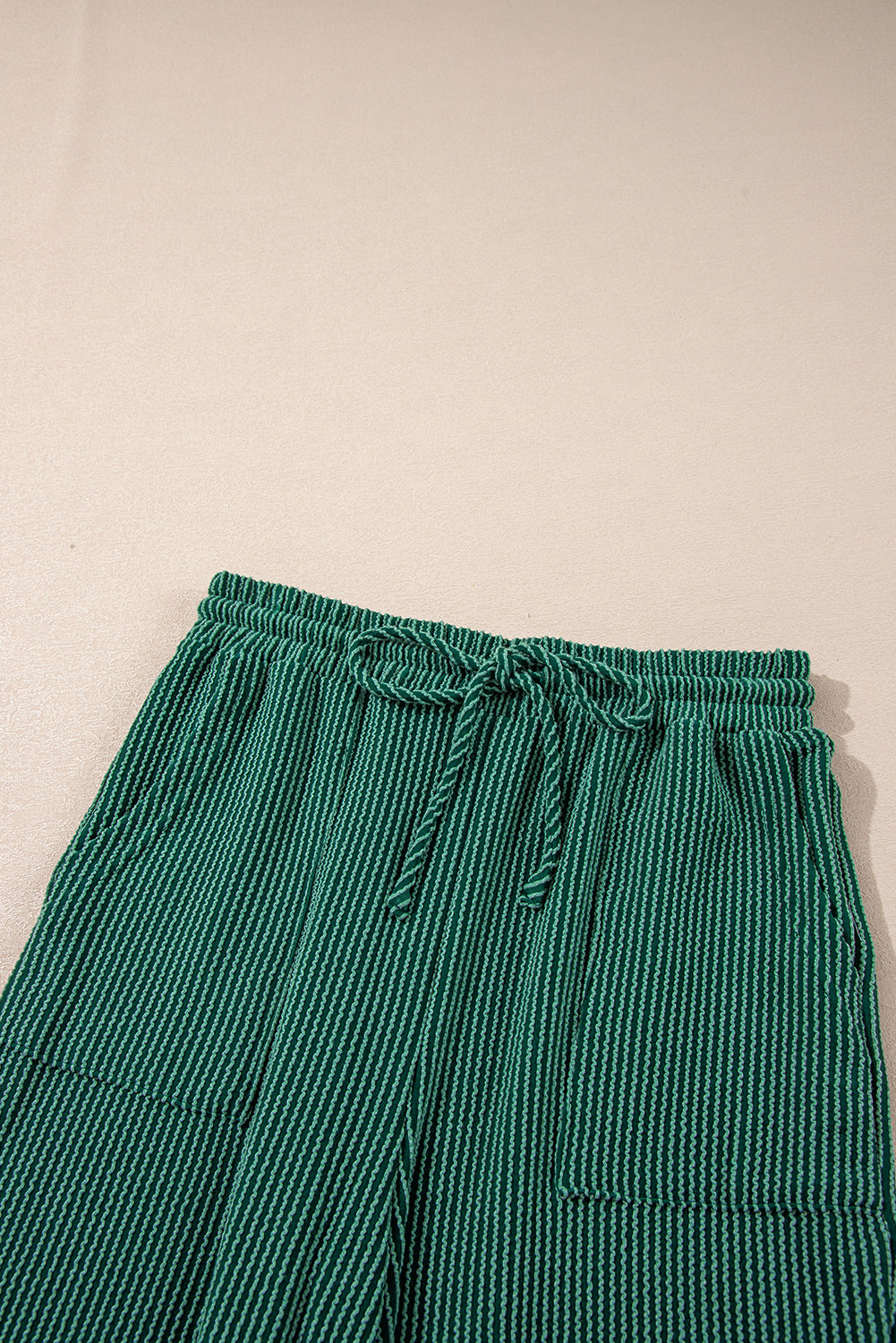 Top view of green Evergreen JOLLY Corded Pants showing drawstring and pockets. Cozy and festive loungewear from Faith & Co. Boutique.