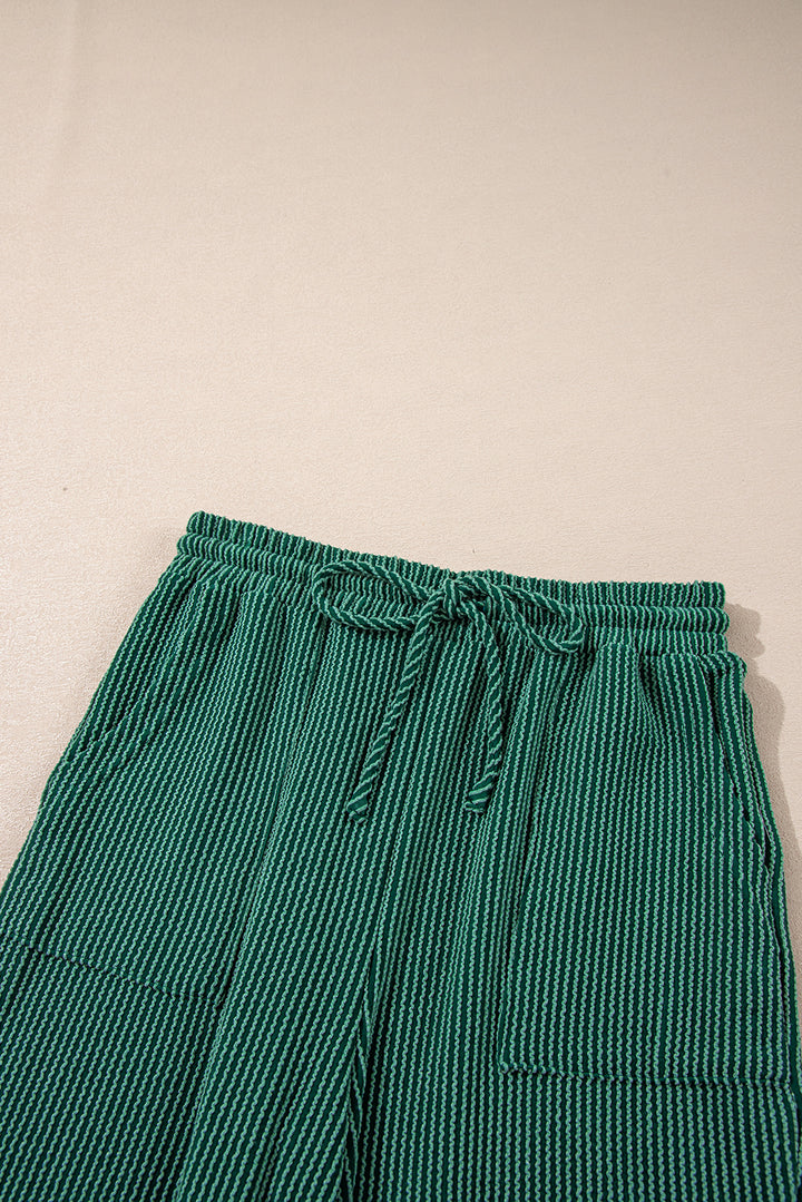 Top view of green Evergreen JOLLY Corded Pants showing drawstring and pockets. Cozy and festive loungewear from Faith & Co. Boutique.