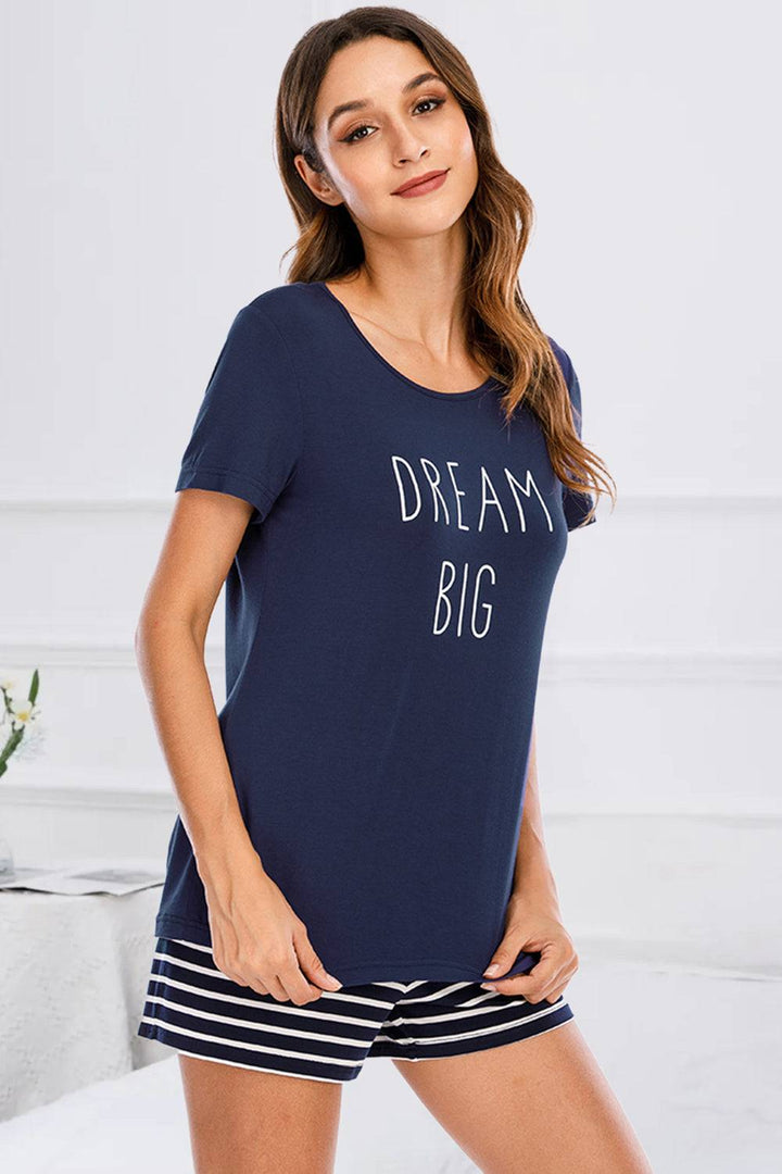 a woman wearing a pajamasuit with the words dream big on it