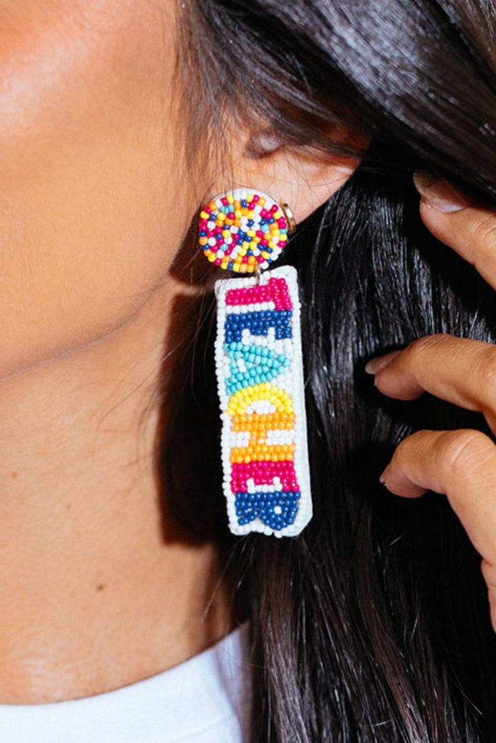 a close up of a person wearing a pair of earrings