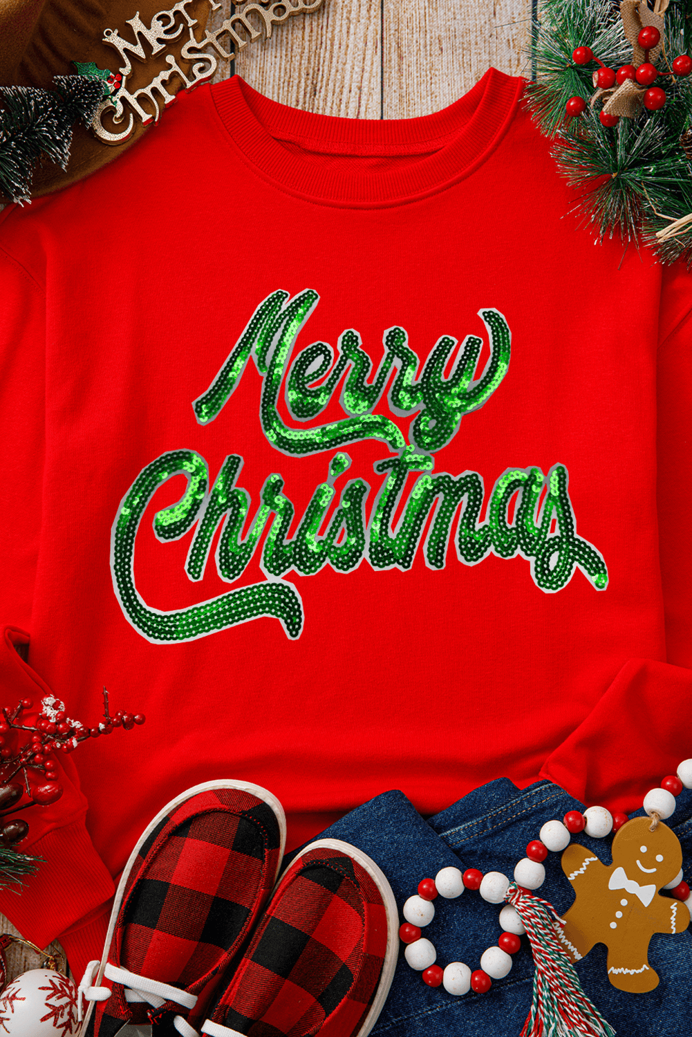 Flat lay of Red Merry Christmas Crewneck Drop Shoulder Loose Sweatshirt styled with festive holiday accessories, available at Faith & Co. Boutique.