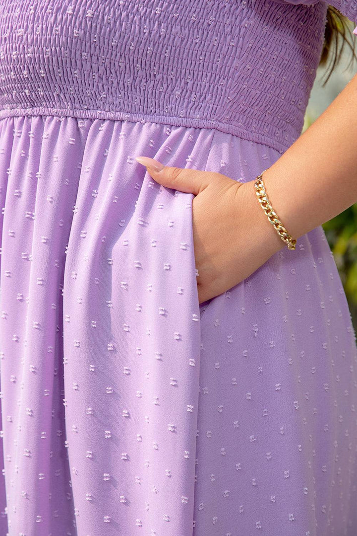 Detailed view of puff sleeve and smocked texture on Wisteria Swiss Dot Smocked Frilled Neckline Plus Size Dress in soft purple hue.