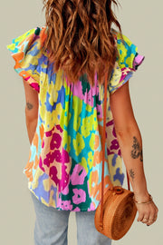 a woman with a hat and a colorful shirt